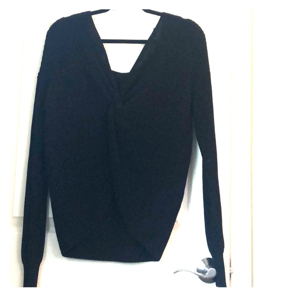 Black sweater knot can be worn front or in back.